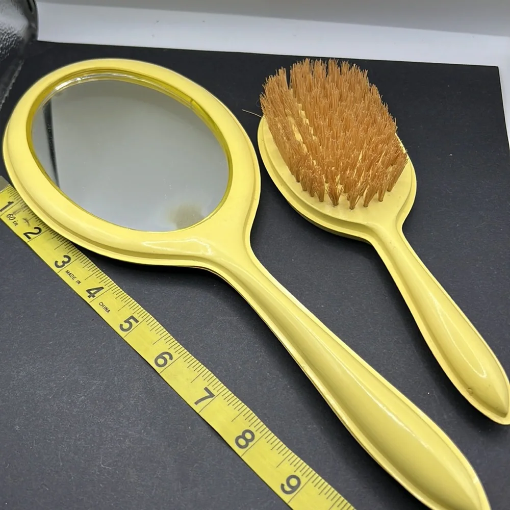 Vintage yellow celluloid vanity mirror, comb and brush set